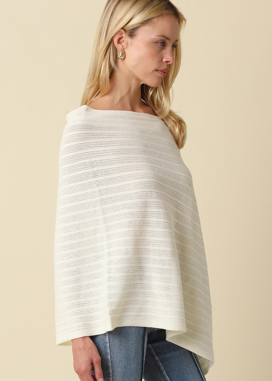Our Lilia Asymmetrical Knit Poncho Top features a relaxed, draped silhouette with a soft, lightweight knit texture. Designed with an off-shoulder neckline and asymmetrical hem, this top creates an effortless, flowy shape with a modern edge. The breathable textured fabric allows for easy layering, while the loose fit offers all-day comfort without feeling bulky. Finished with subtle horizontal texture and fluid movement, it's perfect for casual styling with a refined touch.