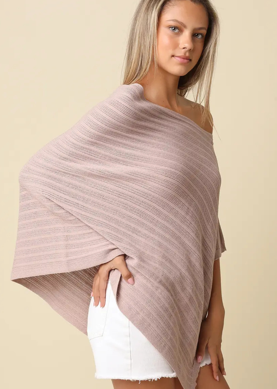Our Lilia Asymmetrical Knit Poncho Top features a relaxed, draped silhouette with a soft, lightweight knit texture. Designed with an off-shoulder neckline and asymmetrical hem, this top creates an effortless, flowy shape with a modern edge. The breathable textured fabric allows for easy layering, while the loose fit offers all-day comfort without feeling bulky. Finished with subtle horizontal texture and fluid movement, it's perfect for casual styling with a refined touch.