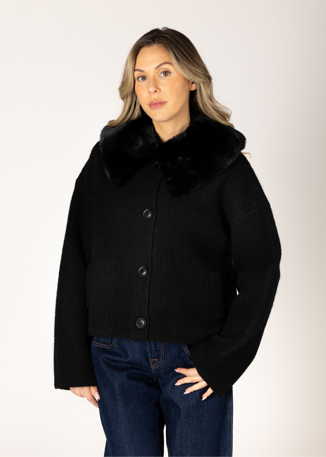 This chic, short coat offers an instant dose of high-impact glamour with its removable, plush eco faux-fur collar. The shortened silhouette provides a flattering, contemporary fit while ensuring maximum warmth. Featuring deep pockets and a soft, luxurious fabrication, this outerwear piece will keep you feeling both polished and cozy all season long.