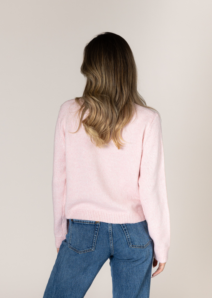 This charming pink cardigan features daisy adorned neckline and placket, adding a playful yet sophisticated touch. With its versatile design and attention to detail, it's perfect for elevating both casual and formal looks. The cozy fit and unique button accents make it a timeless wardrobe staple.