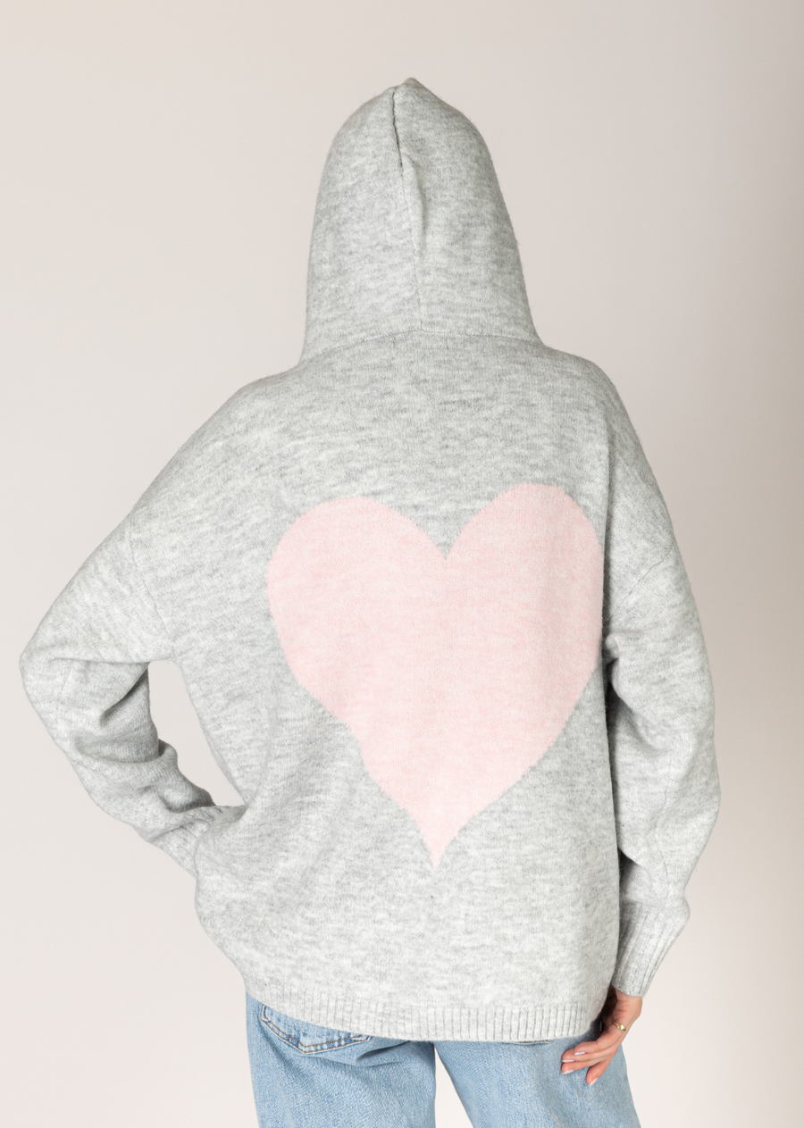 Stay cozy and cute with this relaxed light grey hoodie, featuring a playful pale pink heart design on the back. The soft knit fabric and dropped hem make it perfect for layering, while the hood adds extra warmth and style. A charming choice for casual days.