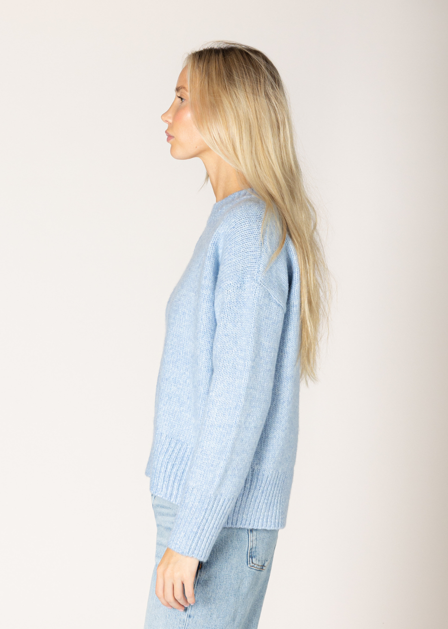 This classic crew sweater fits seamlessly into any wardrobe. This sweater offers a clean and stylish look while promising softness and durability. Whether you're layering the Tanya or just wearing it on its own, this sweater is perfect for any occasion.