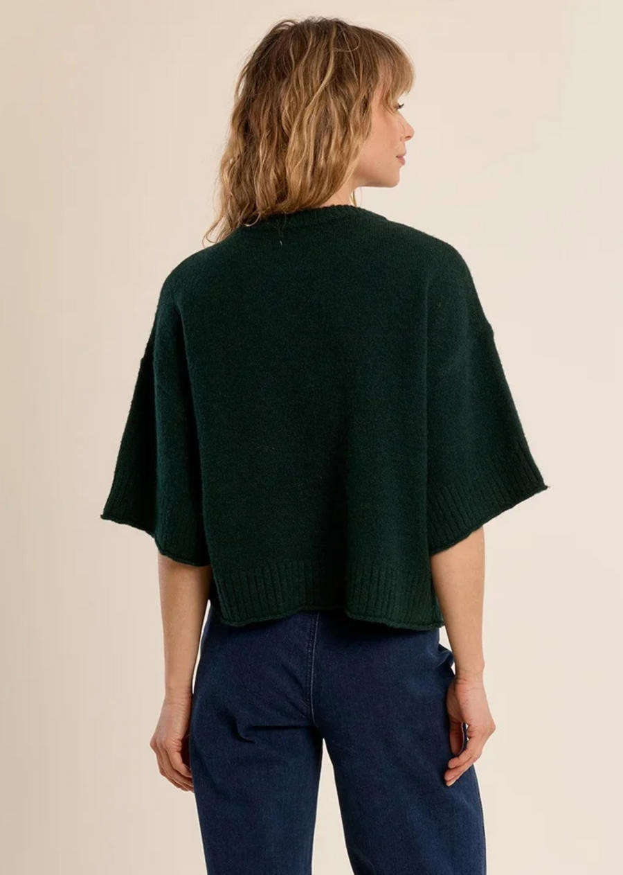 A chic, unexpected twist on classic knitwear, this short-sleeve sweater comes in a rich forest green hue. Crafted from a plush, fuzzy knit yarn, it features an oversized, relaxed silhouette with dramatic dropped shoulders and wide, elbow-length sleeves. Classic ribbed trimming along the crew neckline, wide cuffs, and hem adds subtle structured definition to the effortless drape.