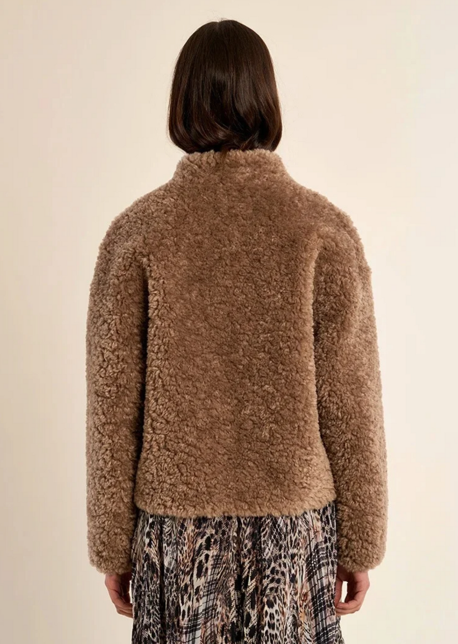 Embrace cold-weather luxury with this cozy plush faux-shearling jacket. Crafted in a warm, sophisticated taupe/taupe-brown shade, this piece features a rich, curled teddy-fleece texture that offers both warmth and statement style. Cut in a relaxed, slightly cropped boxy silhouette, it features a clean collarless stand neckline and dark toggle button closures down the front.