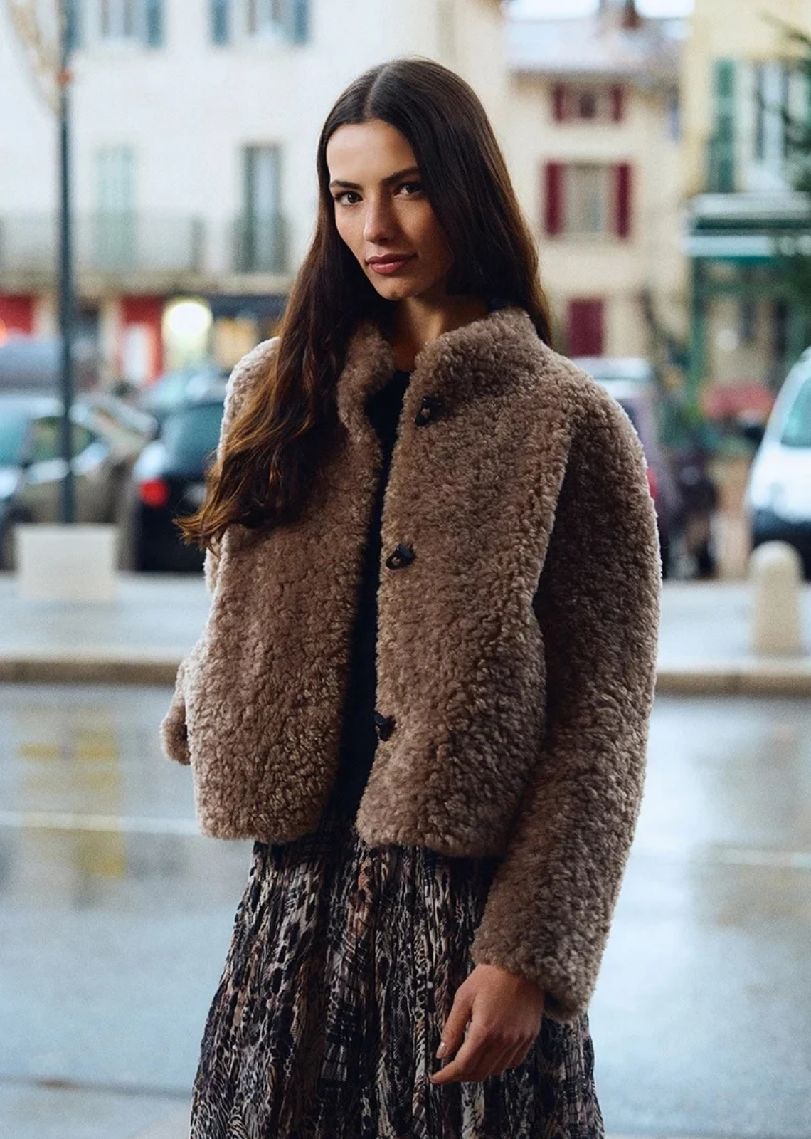 Embrace cold-weather luxury with this cozy plush faux-shearling jacket. Crafted in a warm, sophisticated taupe/taupe-brown shade, this piece features a rich, curled teddy-fleece texture that offers both warmth and statement style. Cut in a relaxed, slightly cropped boxy silhouette, it features a clean collarless stand neckline and dark toggle button closures down the front.