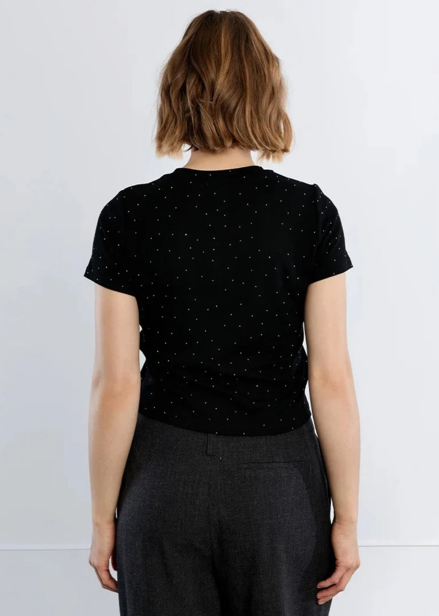 Elevate your everyday tee rotation with this chic, studded classic. Crafted from soft black cotton knit, this fitted short-sleeve tee is dusted with delicate, micro-rhinestone pinpoints that catch the light with every move. Designed with a timeless crew neck and a clean, straight hemline, it offers the perfect balance of effortless edge and playful sparkle. Tuck it into high-waisted tailored trousers for a night out, or pair it with relaxed denim and a leather jacket for casual street-style glamour.