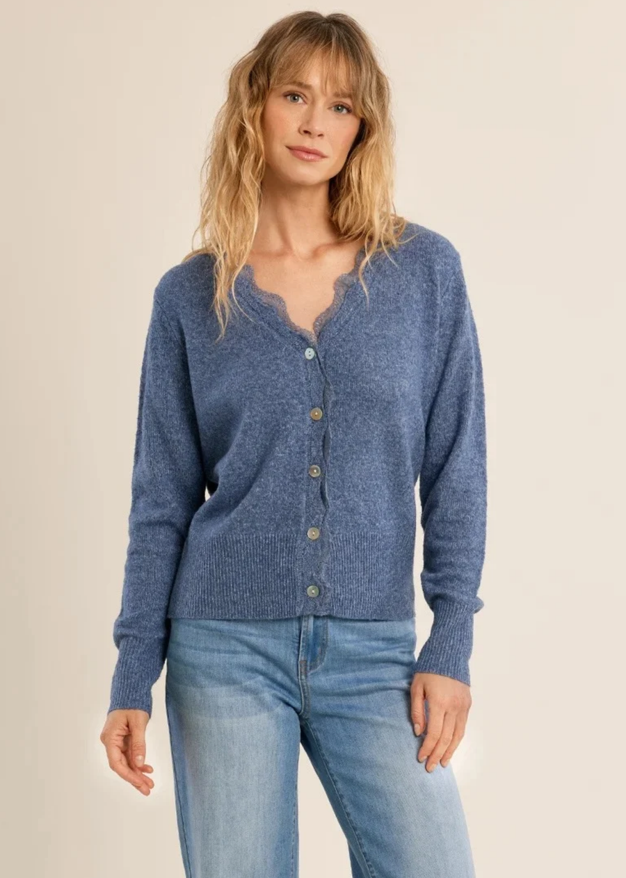 Breathe fresh color into your cozy lineup with this stunning dusty blue cardigan. Crafted from a soft, heathered knit, it features delicate lace trim framing the V-neckline for a soft, feminine finish. Designed with subtle iridescent buttons, fine ribbed cuffs, and an extended ribbed hemline, this piece effortlessly combines romantic detail with everyday comfort. Pair it with high-waisted denim for a classic casual look, or dress it up over a floral dress for transitional weather.