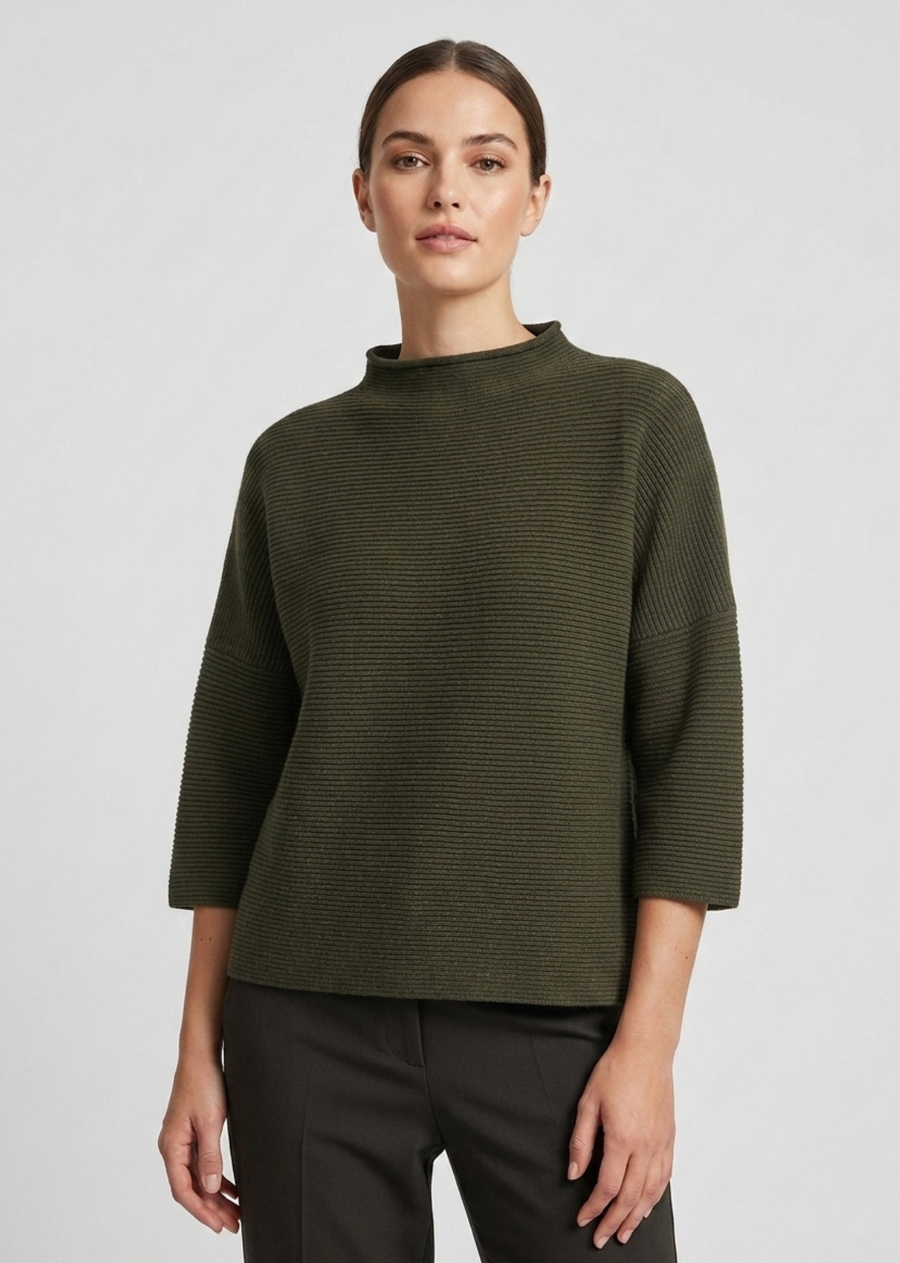 A modern mock-neck knit sweater in a rich forest green tone, featuring a clean horizontal rib texture and relaxed silhouette. Designed with dropped shoulders and modified three-quarter length sleeves, this piece offers a boxy, contemporary drape perfect for effortless layering.