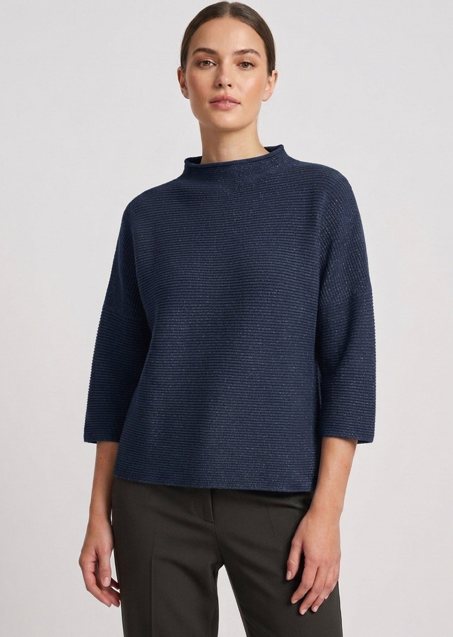 A modern mock-neck knit sweater in a rich forest green tone, featuring a clean horizontal rib texture and relaxed silhouette. Designed with dropped shoulders and modified three-quarter length sleeves, this piece offers a boxy, contemporary drape perfect for effortless layering.