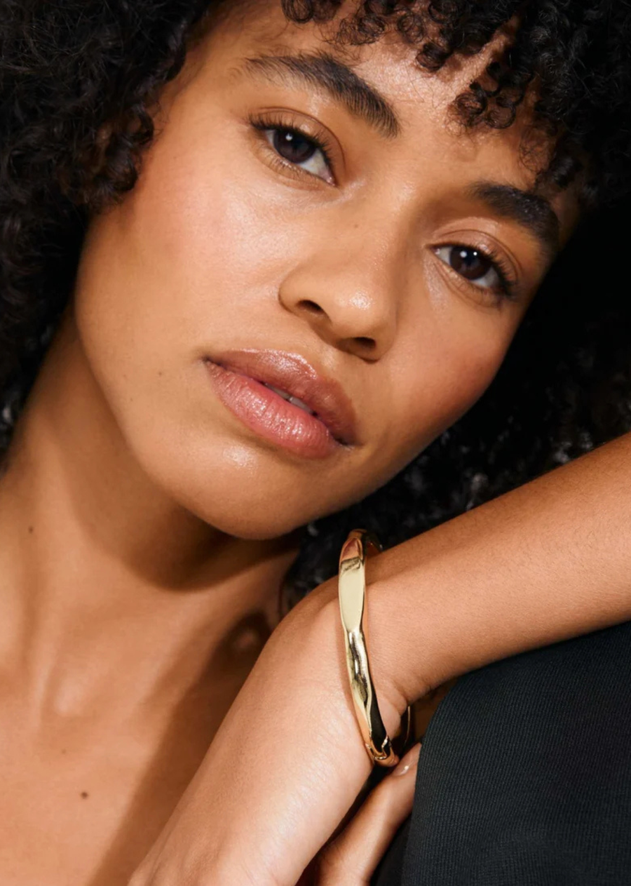 The gold-plated or silver-plated PRESENCE bangle from Pilgrim is all about soft curves, gently faceted surfaces, and a high-shine finish that catches the light just right. It’s got that quiet-luxury vibe—perfect worn solo for understated elegance or stacked up with your favourite bangles for a more playful look. The bracelet fastens with a subtle click clasp and is crafted from 99% recycled materials—because those little details really do make a difference.