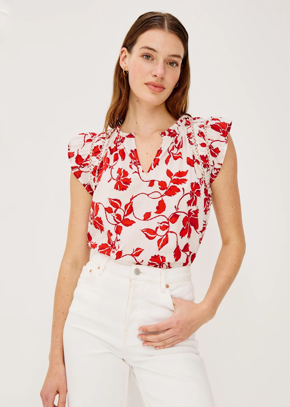 Made from airy, lightly textured poplin, the Allea Top features shirring, lattice, and ruffle trim, flutter sleeves with contrast stitching, a loose silhouette, and a back keyhole with hook-and-eye closure.