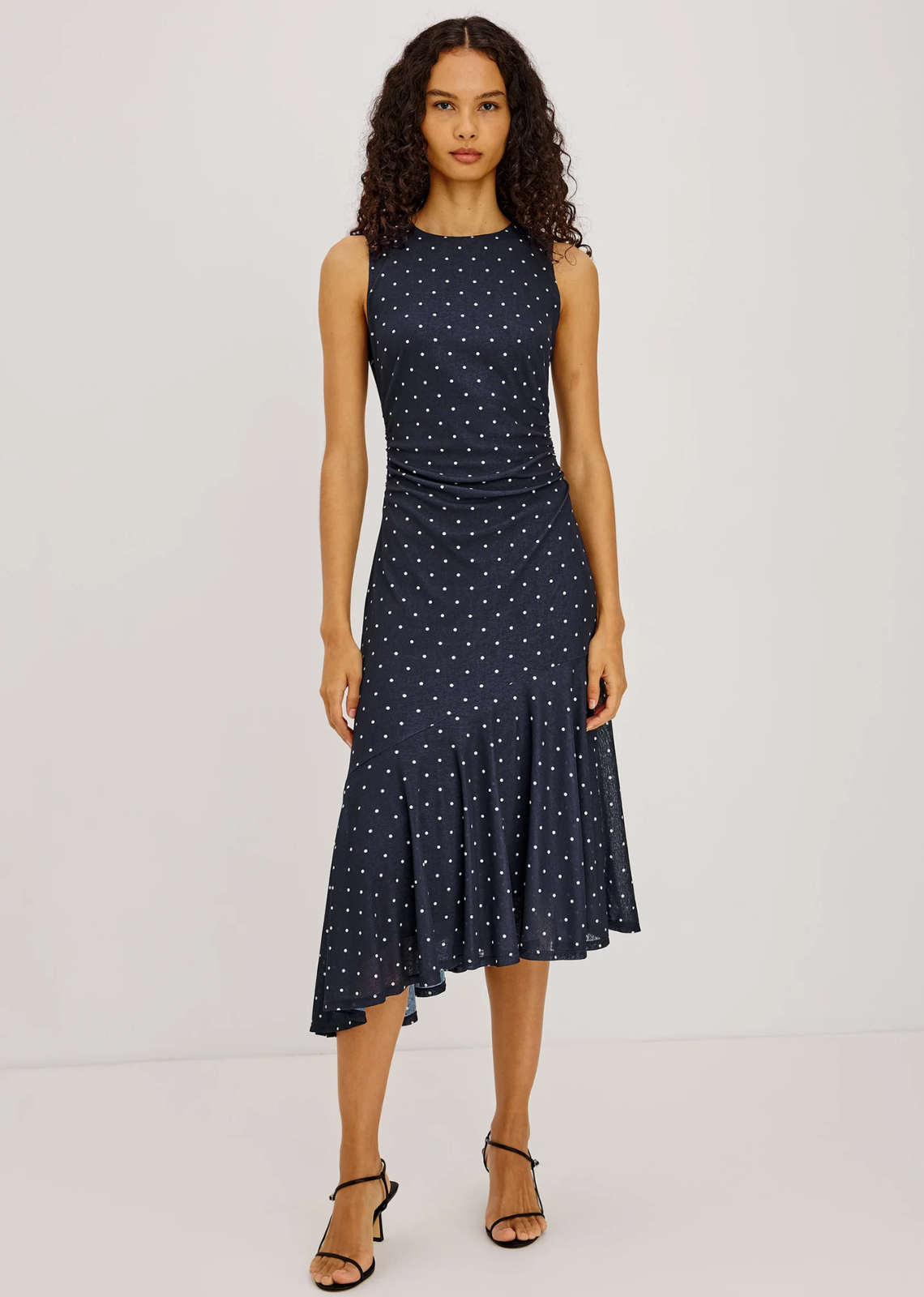Cut from self-lined stretch mesh, the Daija Dress is a midi-length design with a high neckline and fitted bodice, detailed with side waist ruching and an asymmetrically twisted shoulder strap. It falls into a fluted, bias-cut skirt with an asymmetric hem.