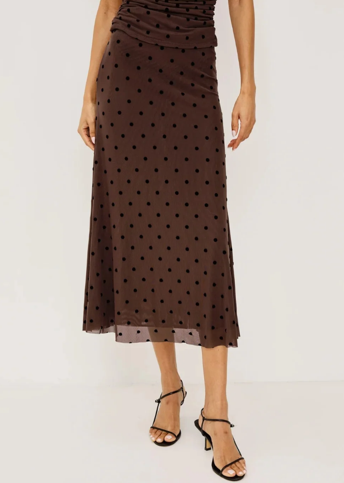 The Jordan Skirt is a high-waisted midi in soft jersey with a fluid A-line silhouette, full lining, a raw hem, and a clean elastic waistband for a comfortable, polished fit.