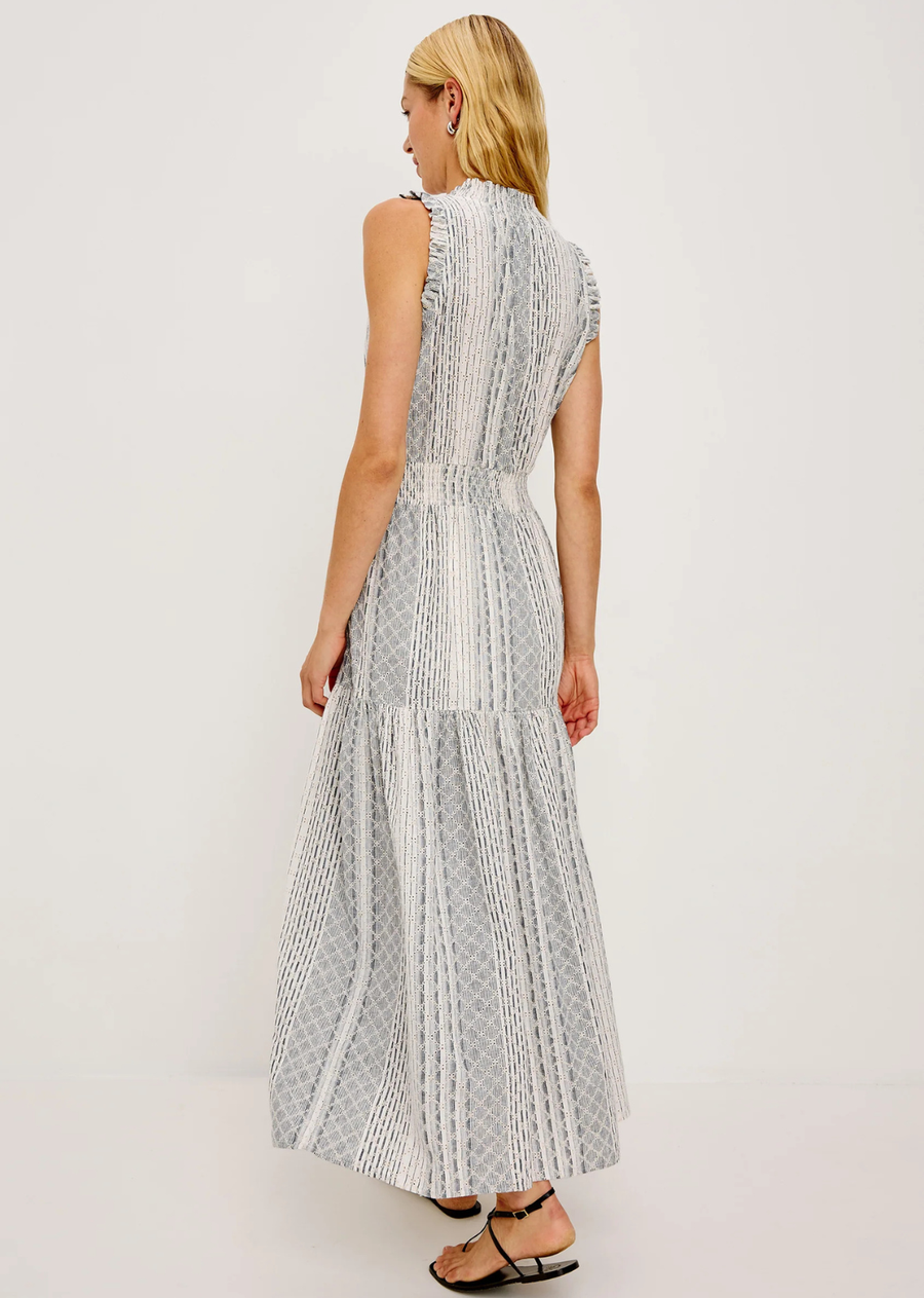 The Alessi is a luxe, lightweight linen midi dress with a relaxed fit, a split V-neckline with self-ties, a smocked waist, ruffle trim, and full lining.