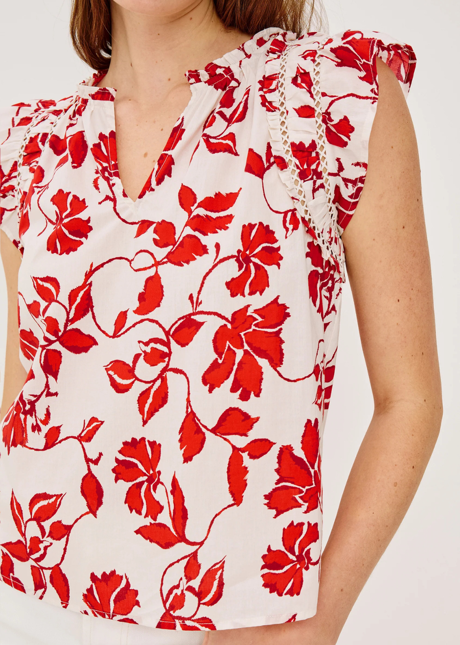 Made from airy, lightly textured poplin, the Allea Top features shirring, lattice, and ruffle trim, flutter sleeves with contrast stitching, a loose silhouette, and a back keyhole with hook-and-eye closure.
