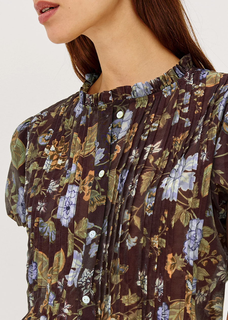 The Pepper Shirt is cut from gently crisp, lightweight cotton poplin in a loose, boxy fit, finished with pintuck detailing, puff cap sleeves, center-front buttons, and a soft peplum hem.