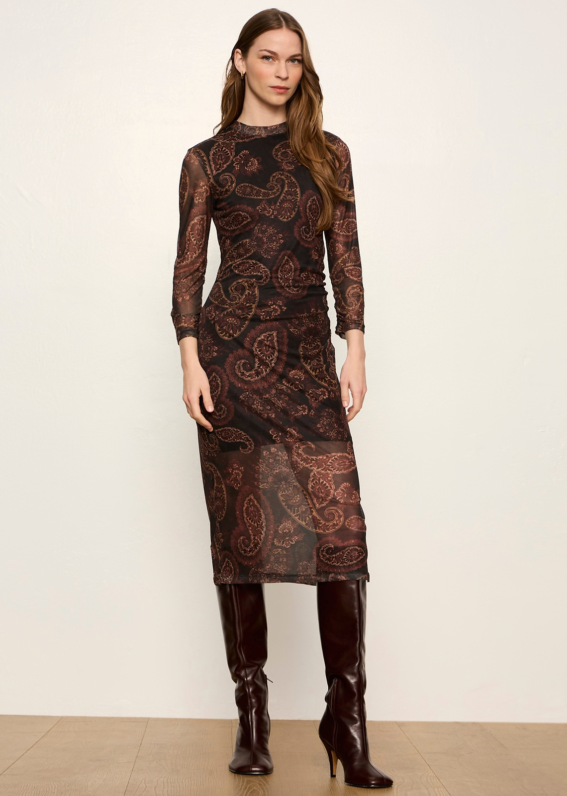 This sophisticated midi dress blends modern bohemian allure with moody, dark-romantic elegance. Crafted from a sheer, semi-transparent mesh fabric overlaid on a solid lining, it pairs dramatic prints with sleek, body-skimming tailoring for an effortlessly chic look.