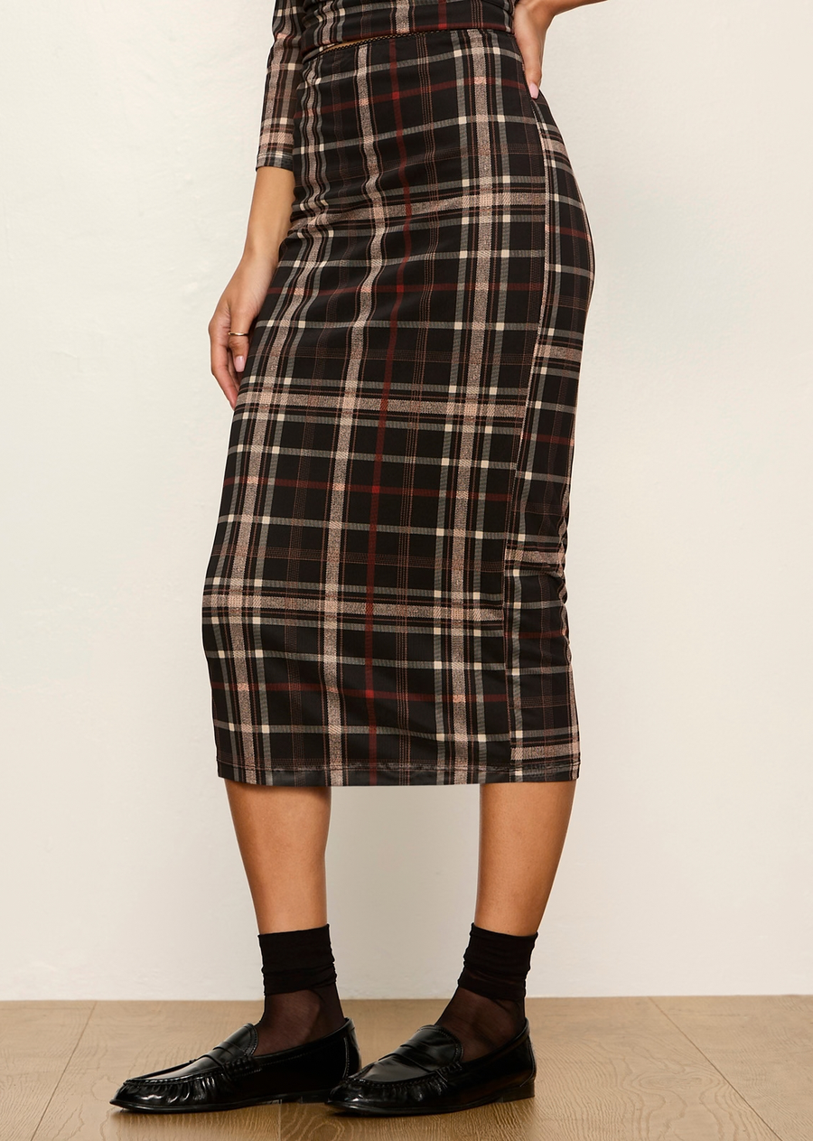 This midi pencil skirt offers a modern, dark-prep twist on classic menswear plaid. Crafted in a lightweight, semi-sheer mesh print overlay with stretch, it delivers a body-skimming profile that bridges casual daytime sophistication with edgy evening style.