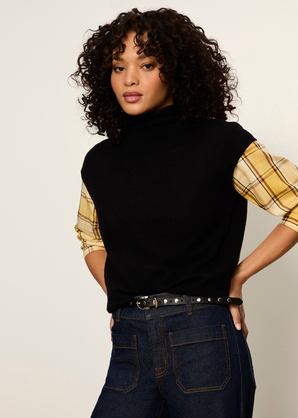 This timeless black sweater vest (or sleeveless mock-neck shell) offers a versatile, modern essential designed for effortless layering. It blends minimalist sophistication with a preppy, autumn-ready feel, making it a functional wardrobe hero across seasons.