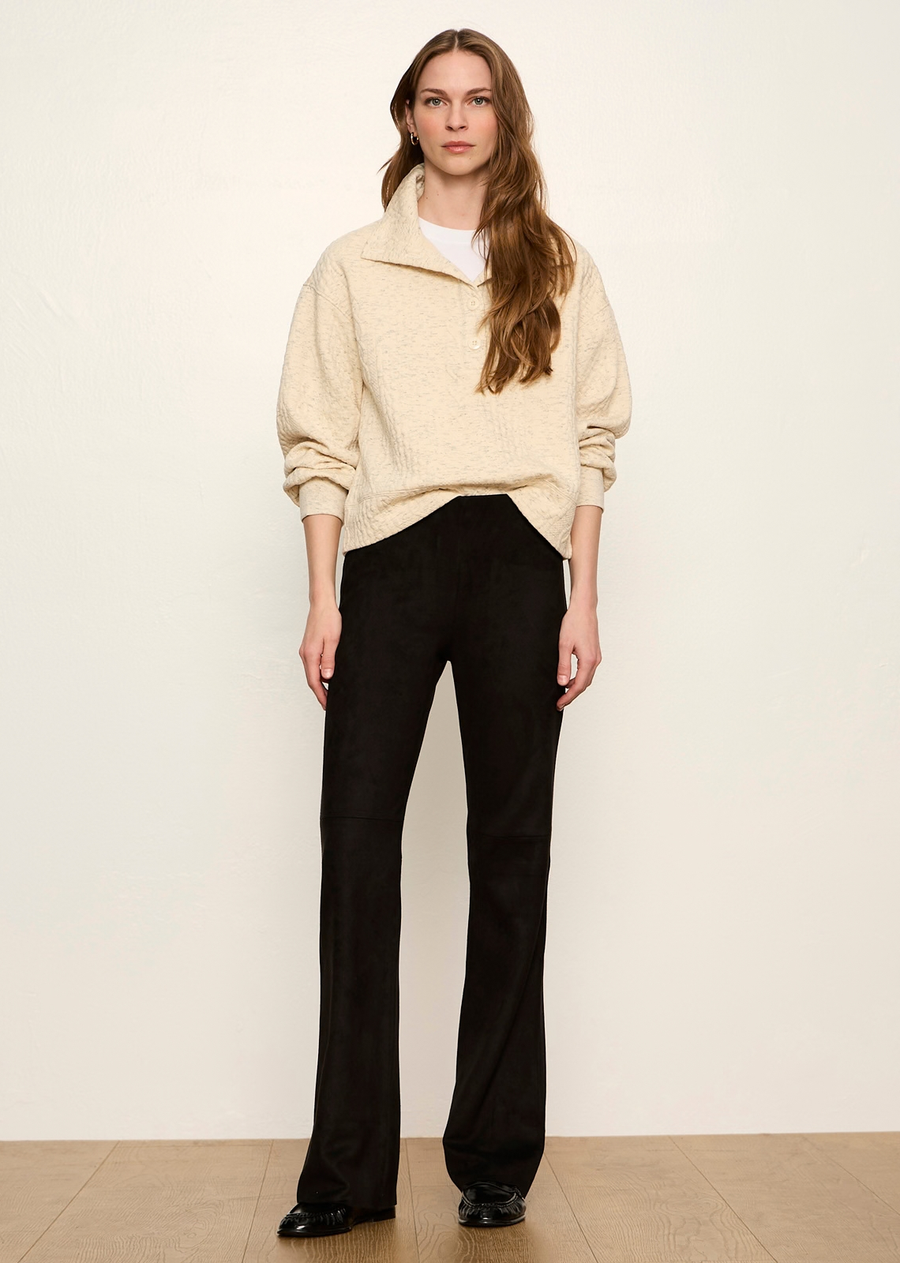 These elevated black leggings combine the plush, velvety texture of suede with the clean structure of tailored pants. Designed with a pull-on fit that contours through the hips and thighs before releasing into a subtle kick-flare, they offer a sophisticated, cozy-chic option for cool-weather dressing.