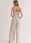 Sadie & Sage Thin Stripe Jumpsuit. Introducing the gorgeous Sands Jumpsuit. Made with a woven fabrication and adorned with a chic striped pattern, this jumpsuit boasts a square neckline, adjustable spaghetti straps, and convenient side pockets.