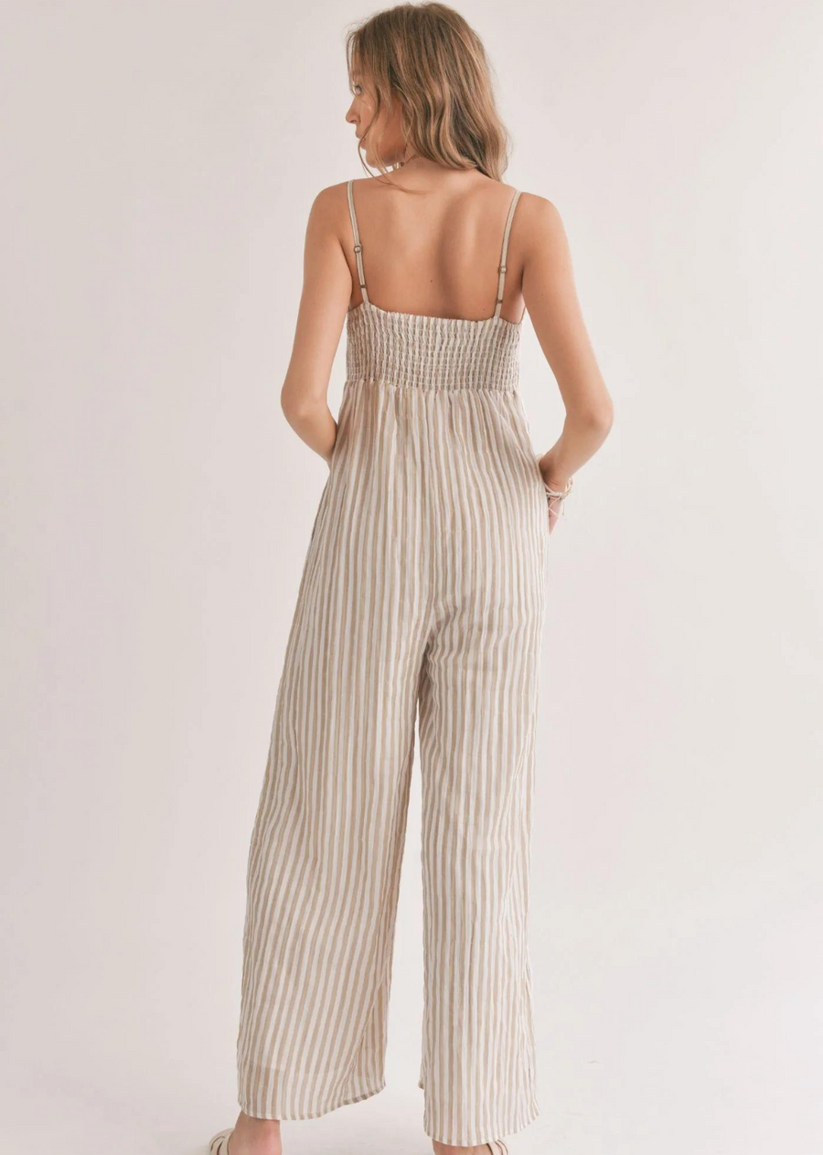 Sadie & Sage Thin Stripe Jumpsuit. Introducing the gorgeous Sands Jumpsuit. Made with a woven fabrication and adorned with a chic striped pattern, this jumpsuit boasts a square neckline, adjustable spaghetti straps, and convenient side pockets.