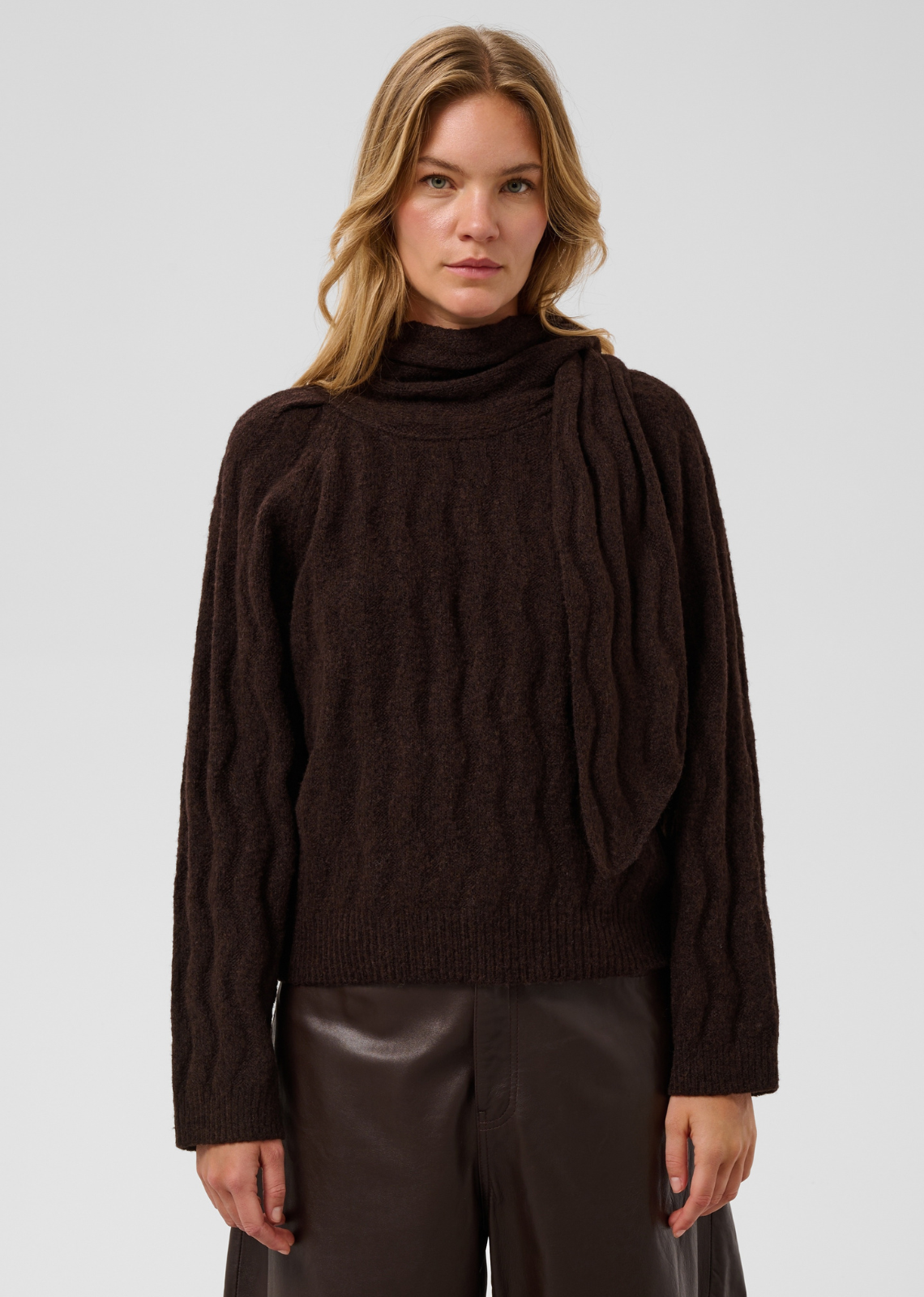 Make a cozy, elevated statement with this textured knit sweater in a rich dark espresso brown. Combining subtle architectural detailing with a lush, tactile finish, it delivers an effortlessly chic, contemporary look.