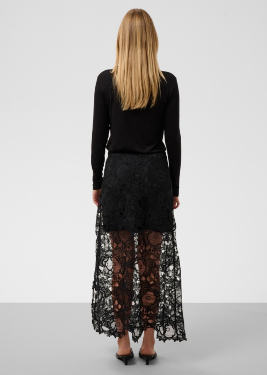 Sheer lace skirt with straight cut, all-over floral lace, and a raw scalloped hem. Midi length with opaque mini lining for modern layered dimension.