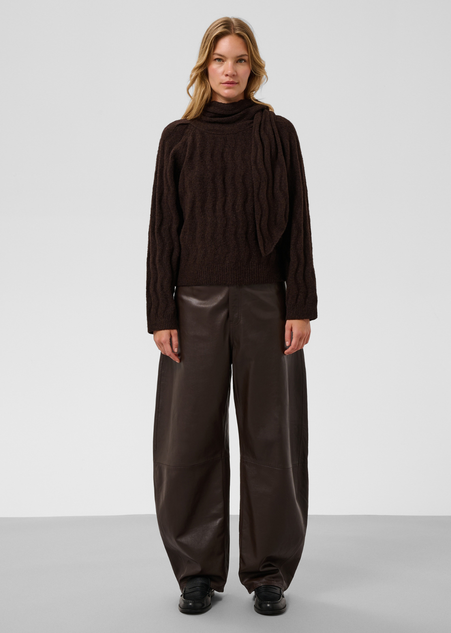 Make a cozy, elevated statement with this textured knit sweater in a rich dark espresso brown. Combining subtle architectural detailing with a lush, tactile finish, it delivers an effortlessly chic, contemporary look.