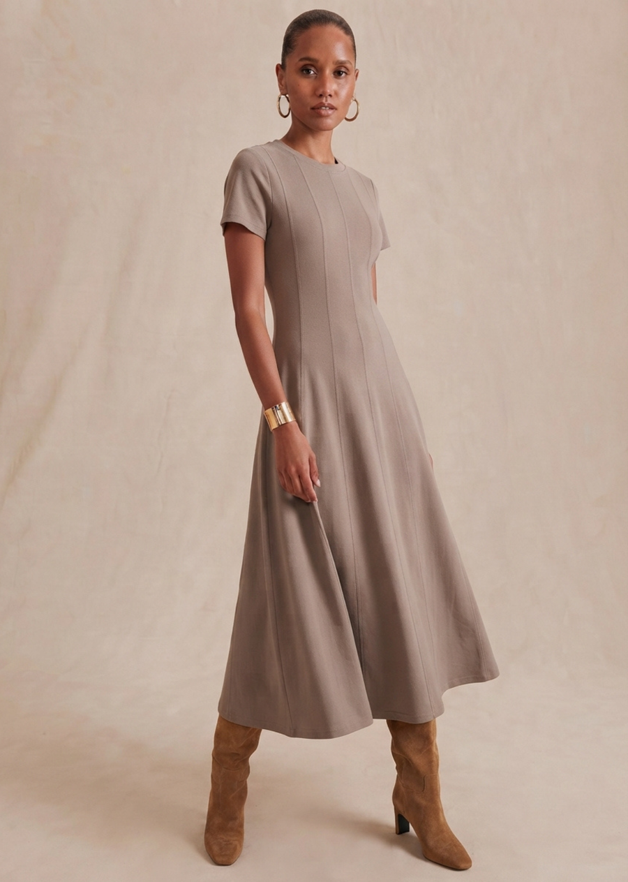 An easy knit dress with a polished feel. Designed with a flattering fit-and-flare silhouette, vertical seam detailing, and soft stretch, it skims the body before flowing into a graceful midi-length hem.