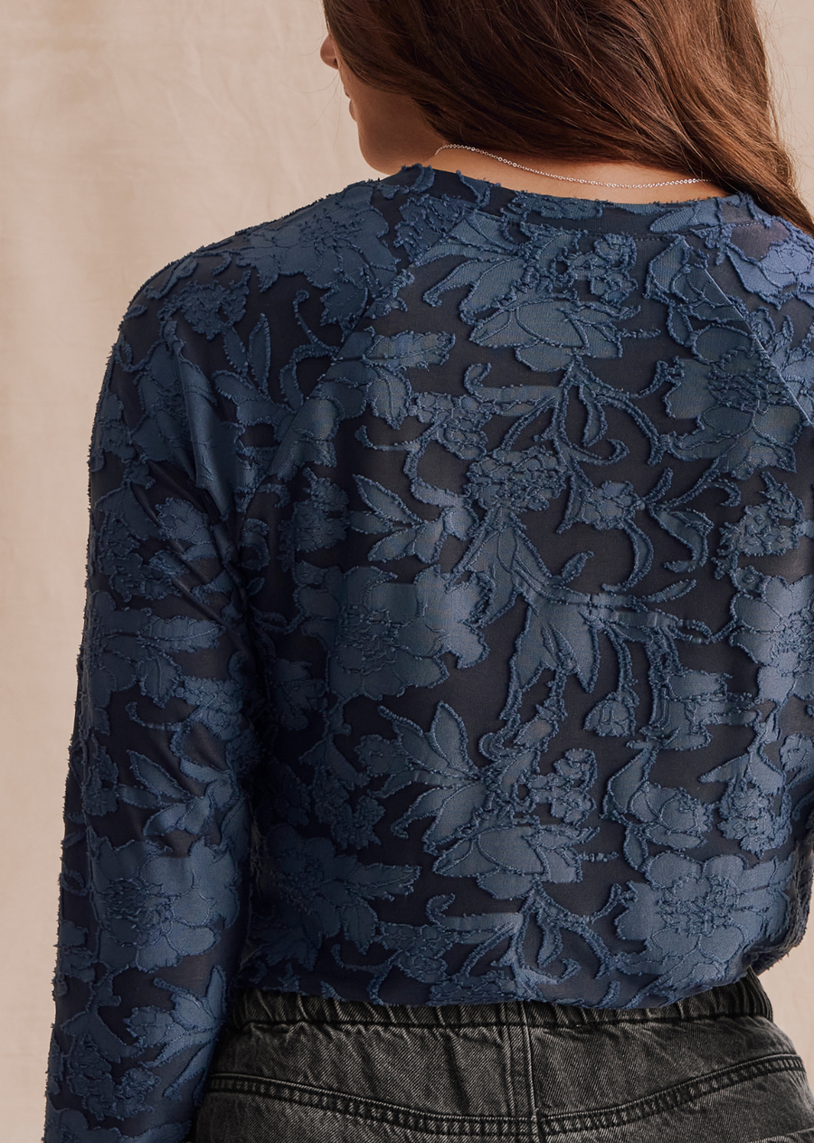 Feminine meets functional in our Cecelia Floral Long Sleeve Tee-- a refined top that feels casual but looks trés chic. Made from a sheer burnout fabric with a lovely embroidered floral pattern. It's bodycon fit is perfect for layering and tucking into jeans. Top it over your own cami for added coverage.