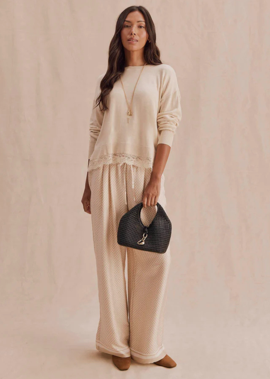 A soft pullover finished with delicate lace trim for a feminine touch. Easy to dress up or down, the Georgie Lace Trim Pullover brings texture and contrast to denim, trousers, and tailored layers.