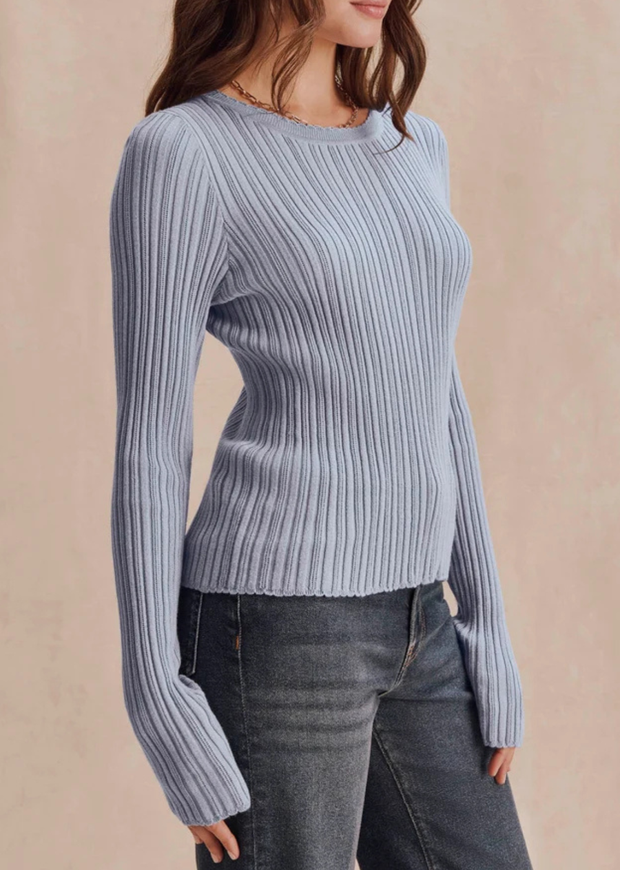 A ribbed pointelle sweater with a fitted silhouette and soft textured feel. The Georgie Pointelle Polo adds a feminine touch to everyday layering with delicate detailing and an easy shape that pairs well with denim, trousers, and skirts.
