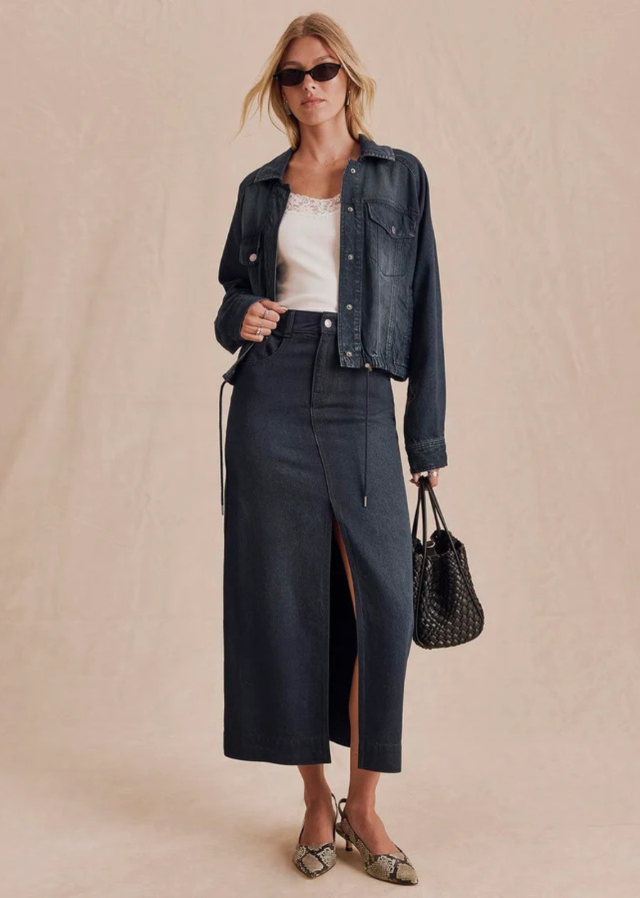 A statement piece with timeless appeal. Crafted from soft suede and designed in a sleek midi silhouette, this skirt balances structure and movement with a front slit that adds just the right amount of edge.