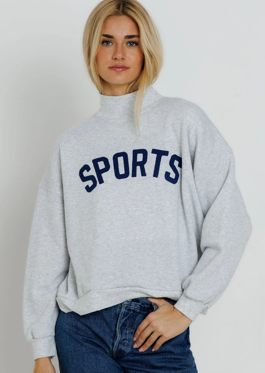 Our Mockneck sweatshirt offers a relaxed, oversized fit with a cozy, elevated feel. Designed with dropped shoulders and a soft mock neckline, it has an easy silhouette that’s perfect for layering or wearing on its own for an effortlessly laid back look.

The Navy Sports Mockneck brings a vintage athletic feel to your everyday. Sporty, classic, and effortlessly cool, it’s inspired by old school team gear and days spent cheering from the sidelines. Made for game days, weekend errands, and wherever the season 