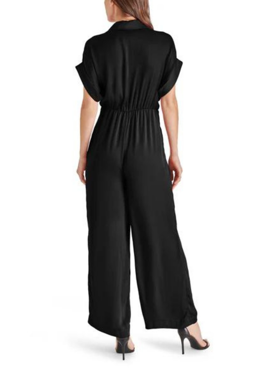 Steve Madden Tori Jumpsuit. Introducing the TORI jumpsuit. This washed satin jumpsuit features a tie front detail, wide-leg pants, and dolman sleeves. With a button front, collar neckline, and rolled sleeves, this jumpsuit is perfect for any season. Elevate your style with this satin beauty.