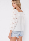 Tavi Embroidered Blouse. An ultra-charming cotton blouse for spring and summer. Featuring voluminous 3/4 length sleeves, a split v-neckline with ties, and delicate embroidered lace details. We love to pair this effortlessly chic style with vintage denim.