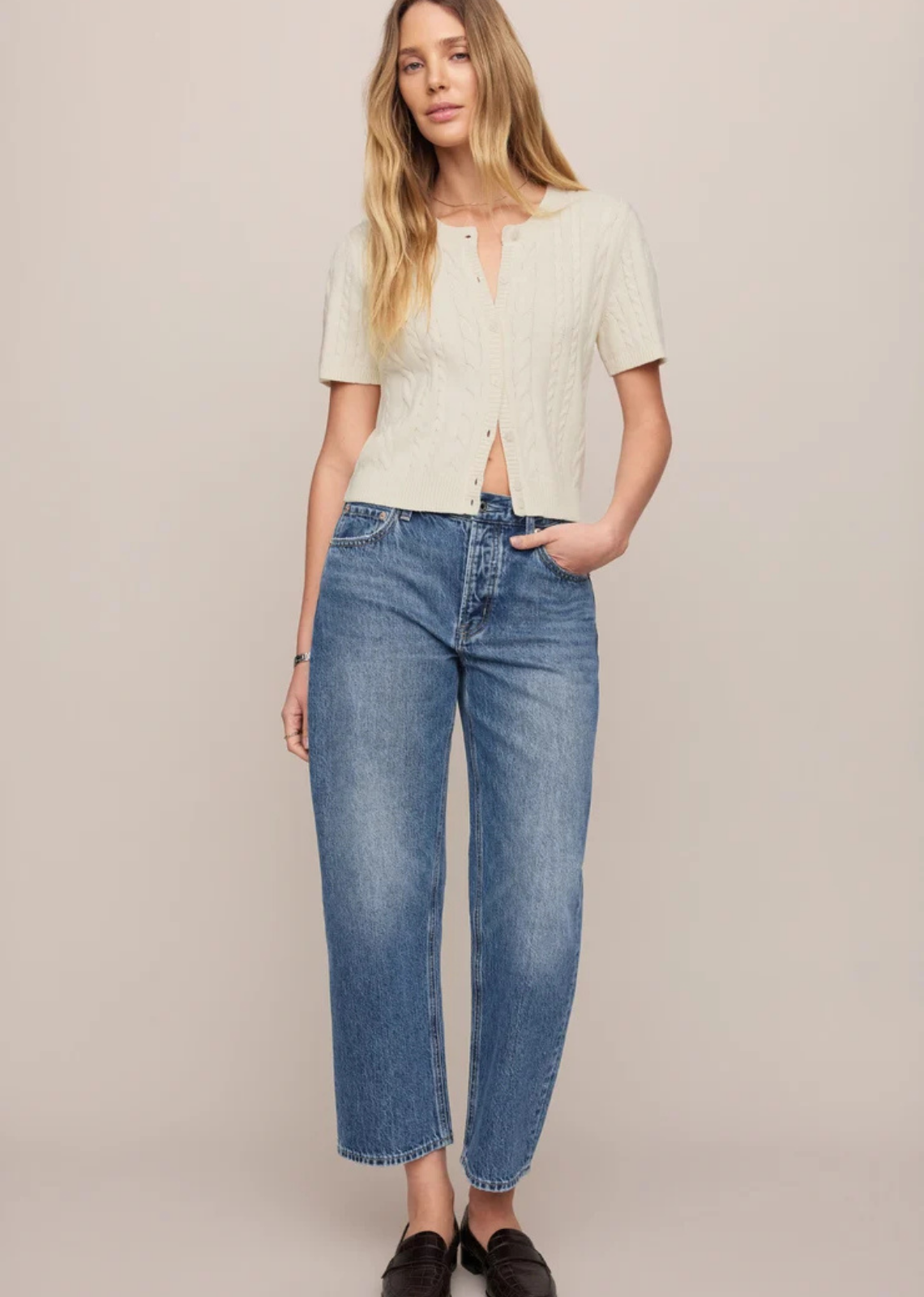  Vintage-wash mid-rise jeans featuring a relaxed bowed-leg silhouette, ankle-length hem, and classic five-pocket design in 100% cotton denim.