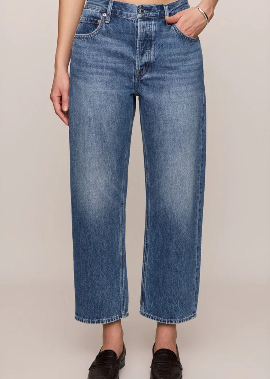  Vintage-wash mid-rise jeans featuring a relaxed bowed-leg silhouette, ankle-length hem, and classic five-pocket design in 100% cotton denim.