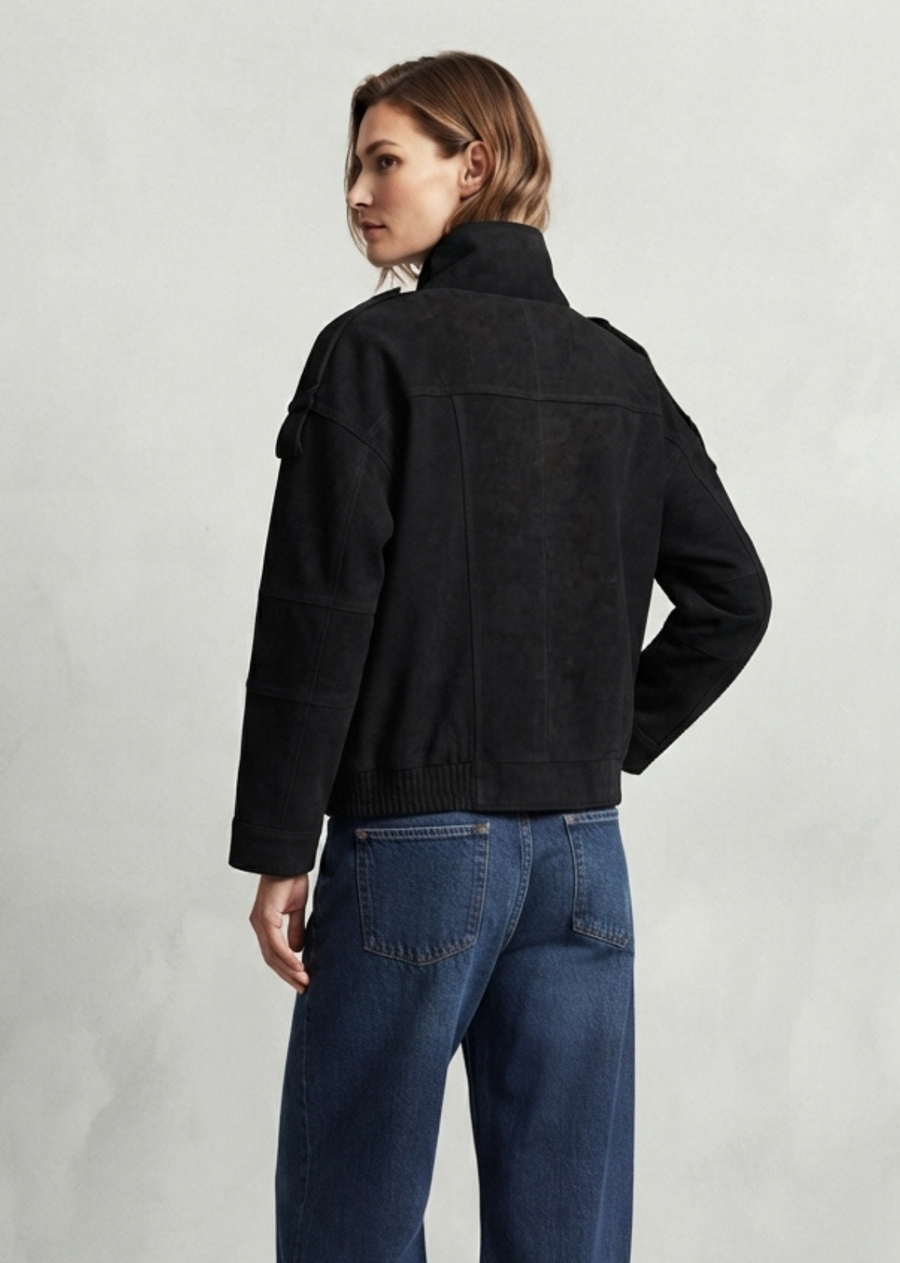 Elevate your transitional wardrobe with the ultimate blend of structure and effortless cool. Crafted with a rich faux-suede and leather finish, this jacket features an asymmetrical snap-front closure, a modern funnel collar, and epaulet shoulder details for a subtle nod to military-chic styling. Designed with a relaxed drop-shoulder and a ribbed elastic hem to lock in shape, it hits the perfect balance between edgy and refined. Style it back to high-rise baggy denim and chunky boots for an effortless weeken