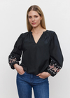 Velvet Paola Embroidered Top. This cotton top features a v-neckline and relaxed fit. The raglan sleeves add a hint of laid-back flair, while the vibrant floral embroidery adds a whimsical charm to your ensemble.