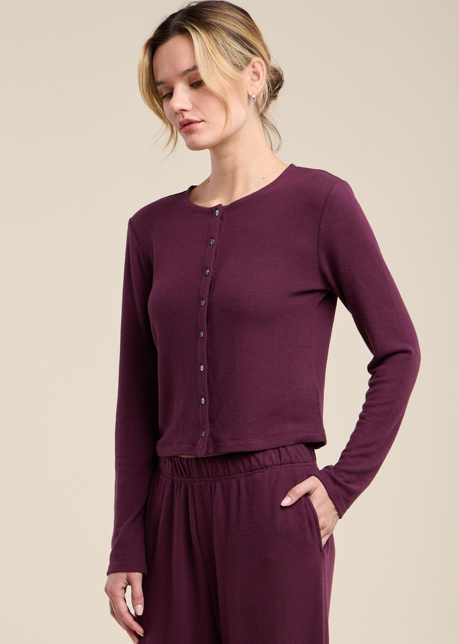 A soft layering essential, the Beatrice is a cropped cardigan crafted from a soft, brushed knit. It features a button-front design and a round neckline for a clean, versatile silhouette. The knit offers an ultra-soft, plush hand-feel with just enough stretch for easy movement. Wear it buttoned over a tank, or open over a dress for effortless, everyday layering.
