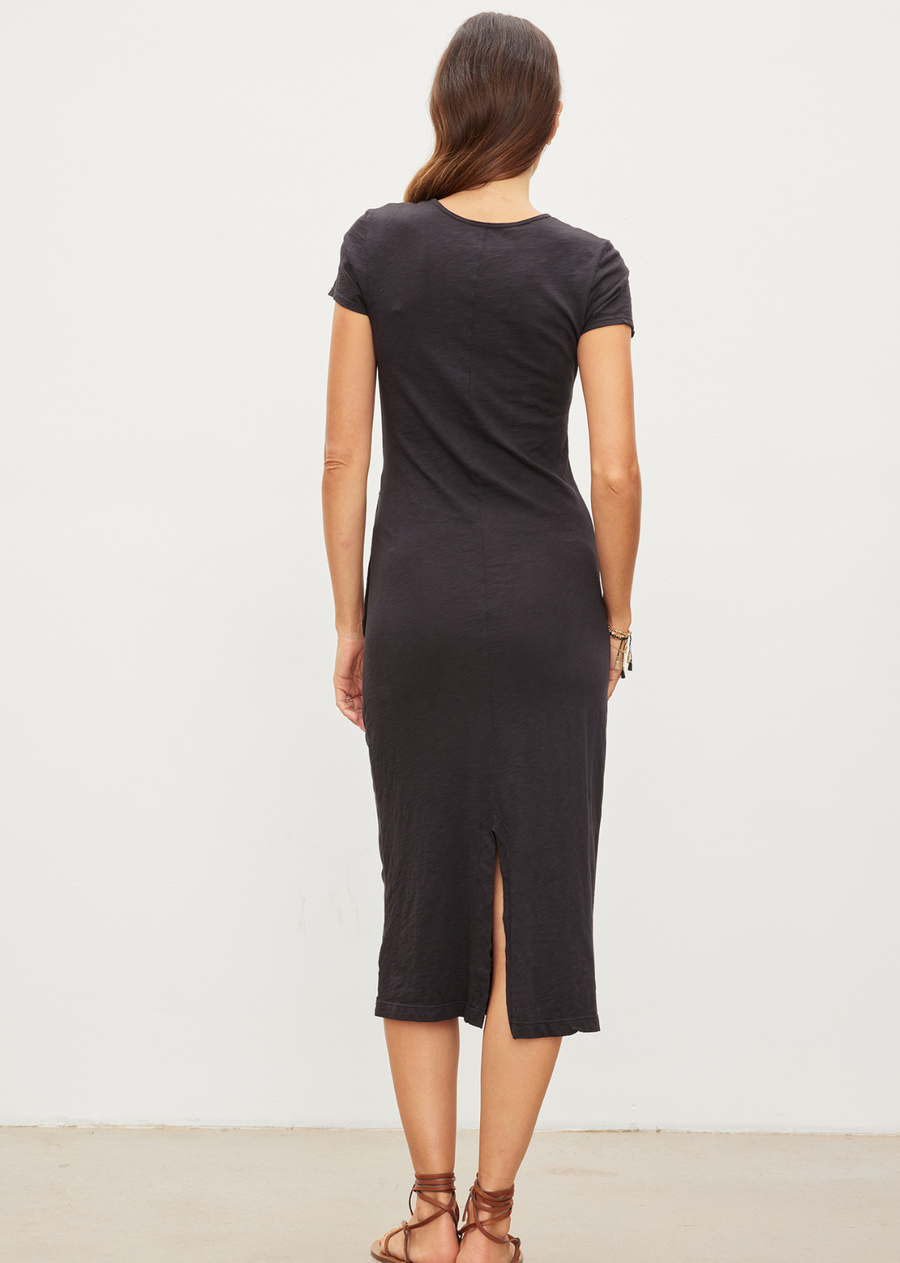 Velvet Darcy Side Tie Dress. Elevate your everyday style with the Velvet by Graham & Spencer Darcy Dress! This mid-length t-shirt dress features a flattering waist knot detail and a back slit for added ease. Made with 100% cotton, it's both casual and comfortable. Perfect for any occasion, this dress is a must-have for your wardrobe.