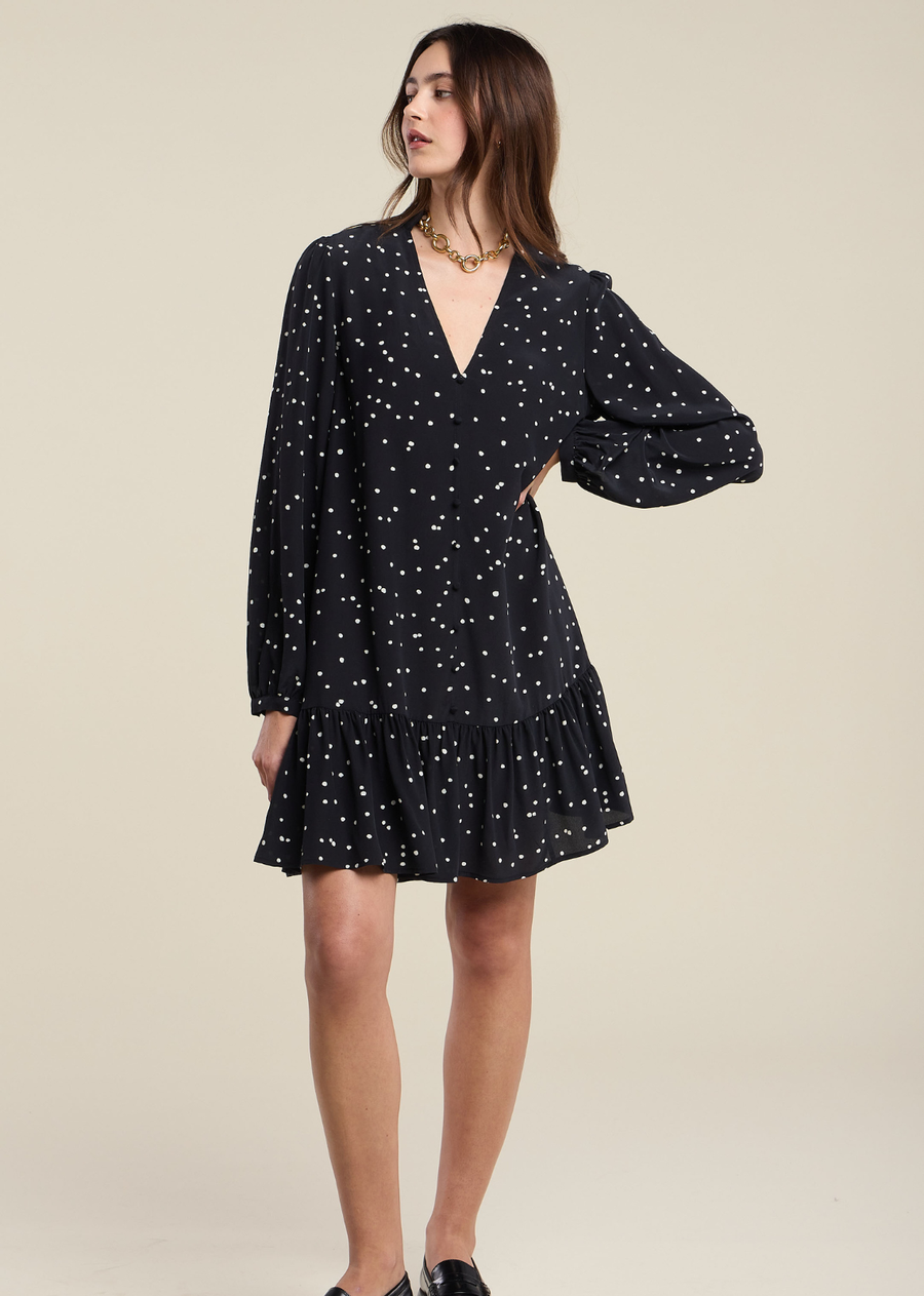 The Elsa silk dress features a flattering V-neckline and long sleeves for refined elegance. A button front and tiered skirt add textural interest and movement to the mini length, creating a modern silhouette perfect for elevated everyday wear or special occasions.
