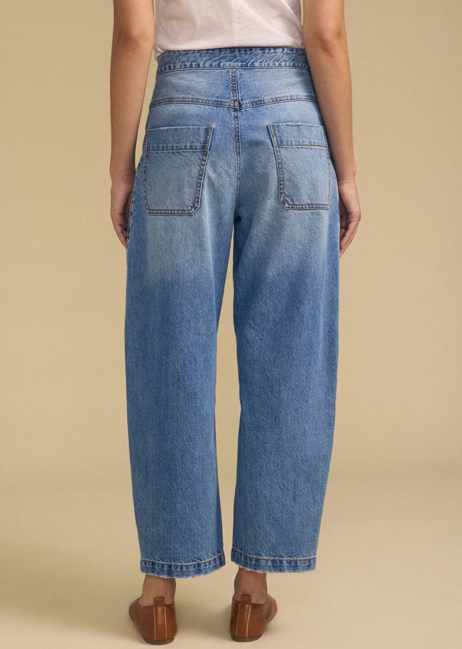 A fresh take on denim, the Esmeralda is a barrel leg jean crafted from cotton denim. It features a button and zipper closure, slash patch pockets, rear patch pockets, and a cropped, raw edge hem for a lived-in finish. The sturdy cotton twill holds its rounded, voluminous shape while remaining comfortable throughout the day.