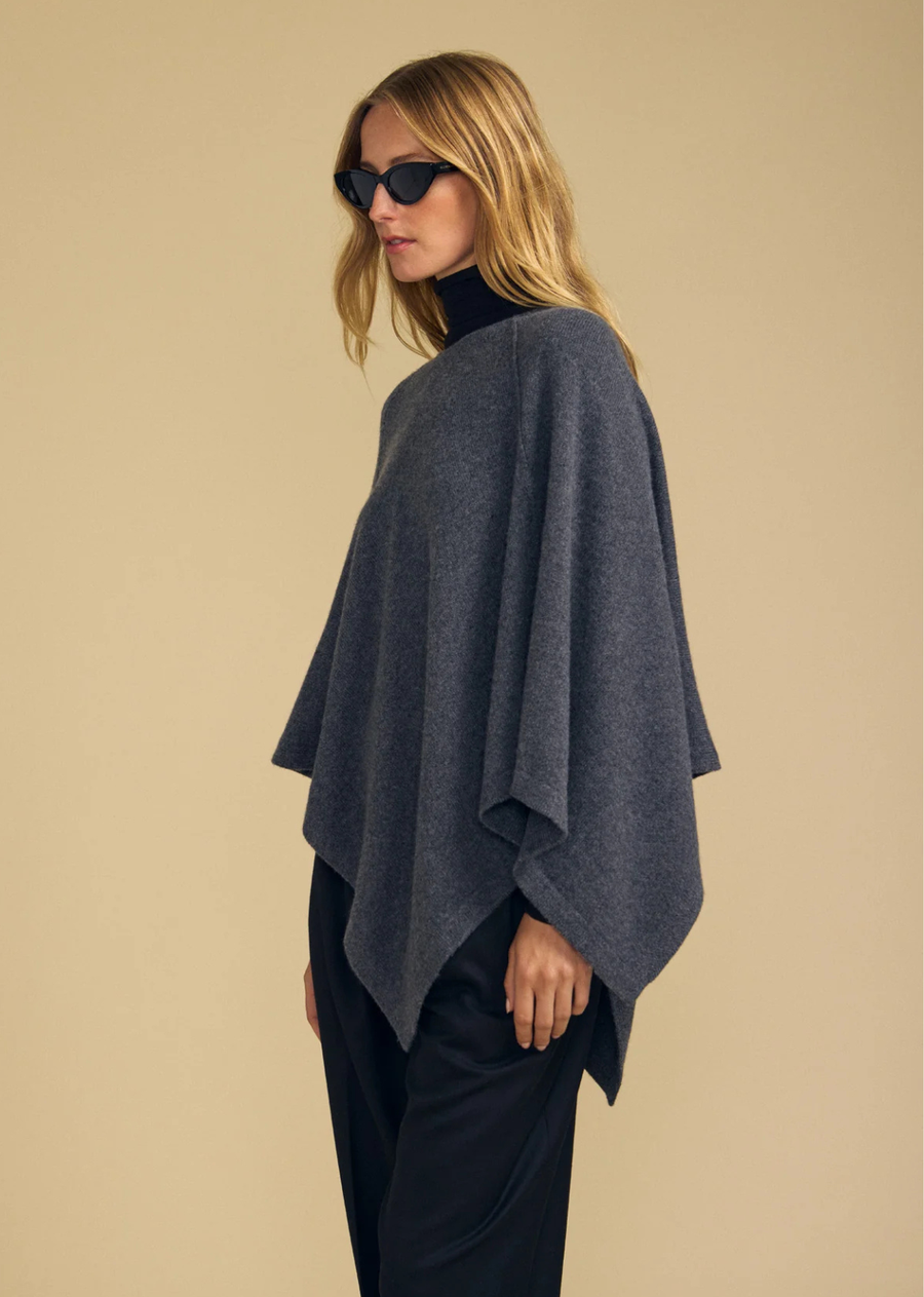 Effortlessly cozy, the Gia is a merino wool blend poncho designed for easy, drapey layering. It features a round neckline and a relaxed, flowing silhouette that falls beautifully over the body. The soft wool blend offers warmth without bulk, making it simple to throw over a long sleeve tee for instant polish. A one-and-done layering piece for cooler days.