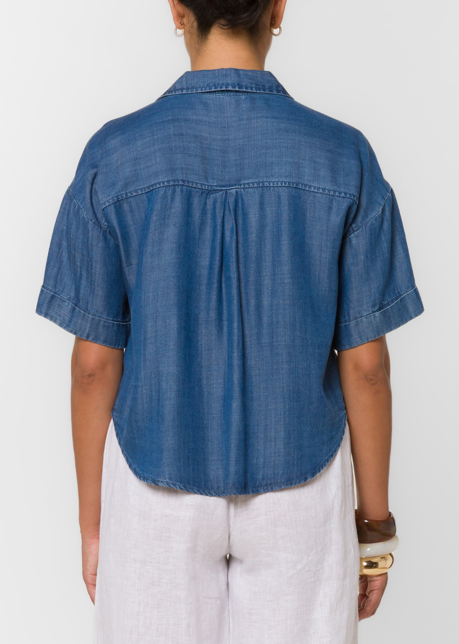 This short sleeve split neck button front top features chest patch pockets and a soft fluid drape.