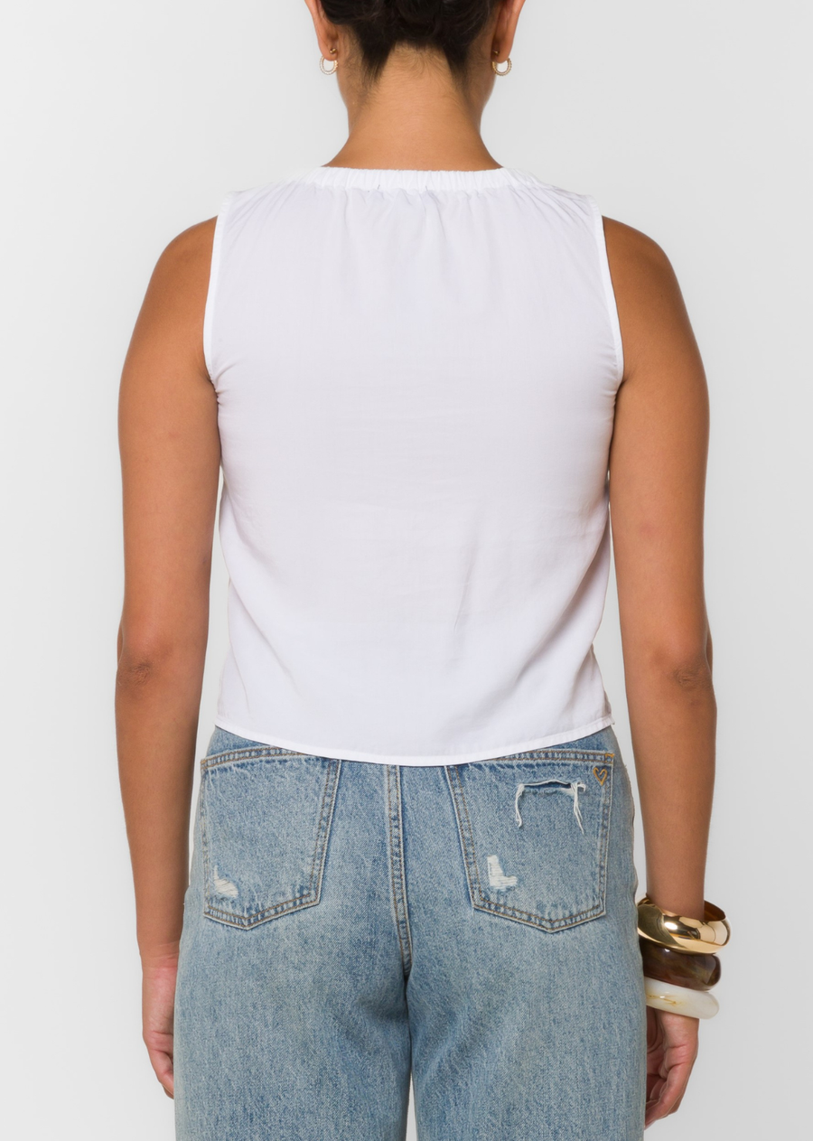 This sleeveless tank features a popover silhouette, double tie-front detail, a soft feel and fluid drape.