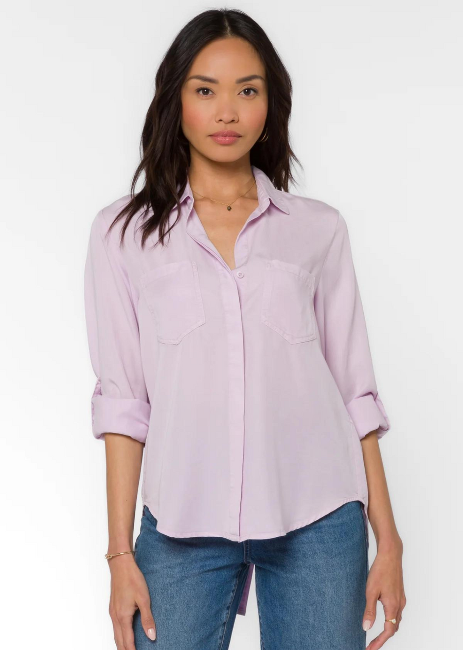 Velvet Heart Riley Shirt- Pastel Lilac. Our classic Riley silhouette, in soft and lightweight eco-friendly Tencel™ features a basic button-up collar, rounded high-low split hem, roll-tab sleeves, and chest pockets.