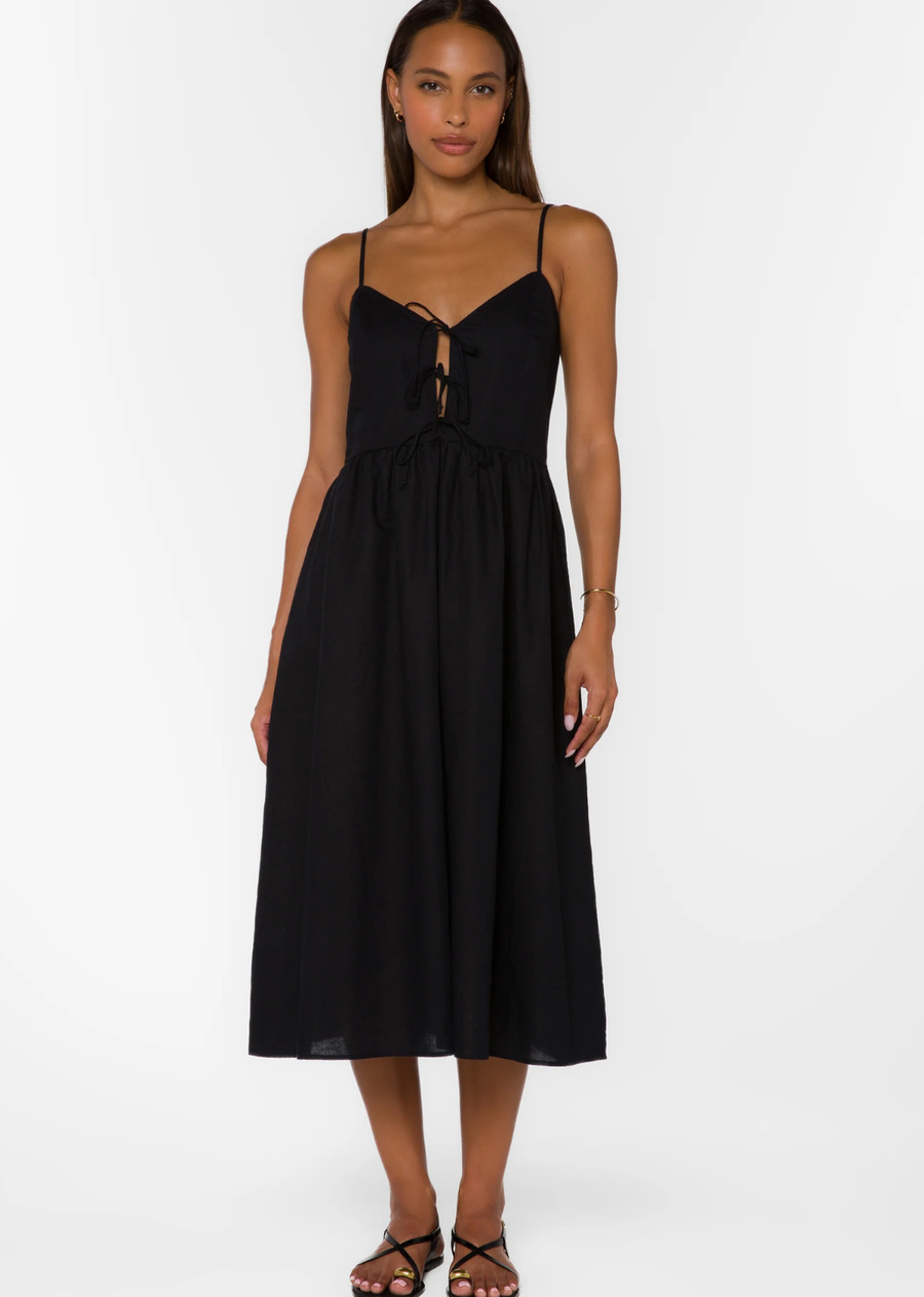 This linen midi sundress features tie-front details adjustable straps and is crafted from a naturally textured linen blend.